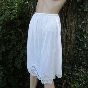 never worn white vintage nylon half slip with original tag and deep lace detail